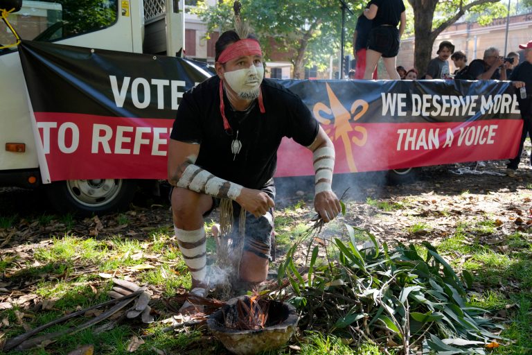 Aboriginal man Josh Sly of the Muggera Dancers prepares a fire for a smoking ceremony at the start of an Invasion Day rally in Sydney, on Jan. 26, 2023. The Australian government on Thursday, March 23, 2023, released the wording of a referendum question that promises the nationâs Indigenous population a greater say on policies that effect their lives.