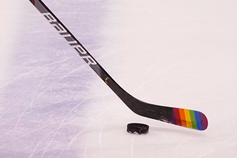 FILE - Florida Panthers center Eetu Luostarinen uses a stick with the LGBT pride flag, March 20, 2021, in Sunrise, Florida.