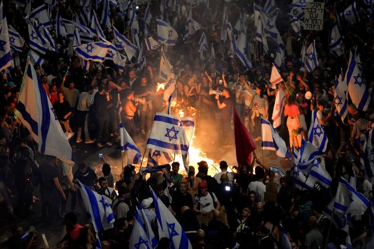Israelis opposed to Prime Minister Benjamin Netanyahu's judicial overhaul plan set up bonfires and block a highway during a protest moments after the Israeli leader fired his defense minister, in Tel Aviv, Israel, Sunday, March 26, 2023. Defense Minister Yoav Gallant had called on Netanyahu to freeze the plan, citing deep divisions in the country and turmoil in the military. 