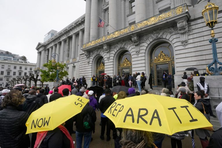 A crowd listens to speakers at a reparations rally outside of City Hall in San Francisco on March 14, 2023. Economists for a California reparations task force estimate the state owes Black residents at least $800 billion for harms in policing, housing, and health. The preliminary estimate will be discussed at the Wednesday, March 29, 2023, meeting of the state reparations task force.