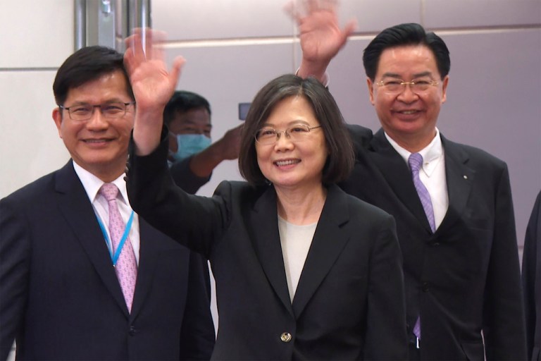In this image made from video, Taiwan's Presidential office secretary general Lin Chia-lung, left, President Tsai Ing-wen, center, and Foreign Minister Joseph Wu wave before Tsai's departure on an overseas trip at Taoyuan International Airport in Taipei, Taiwan, Wednesday, March 29, 2023.