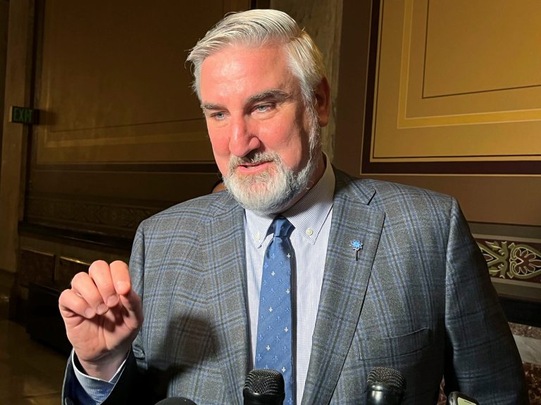 Indiana Gov. Eric Holcomb speaks with reporters at the Indiana Statehouse on Tuesday, April 4, 2023, in Indianapolis. 