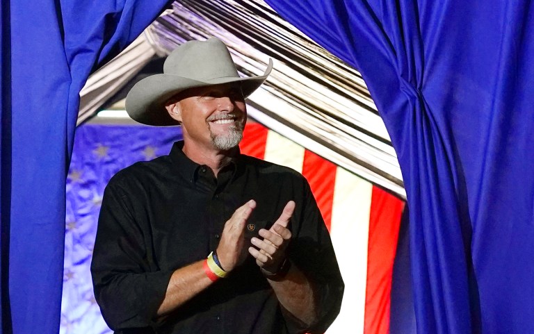 Pinal County Sheriff Mark Lamb applauds as he walks onstage at a Save America Rally Friday, July 22, 2022, in Prescott, Arizona.