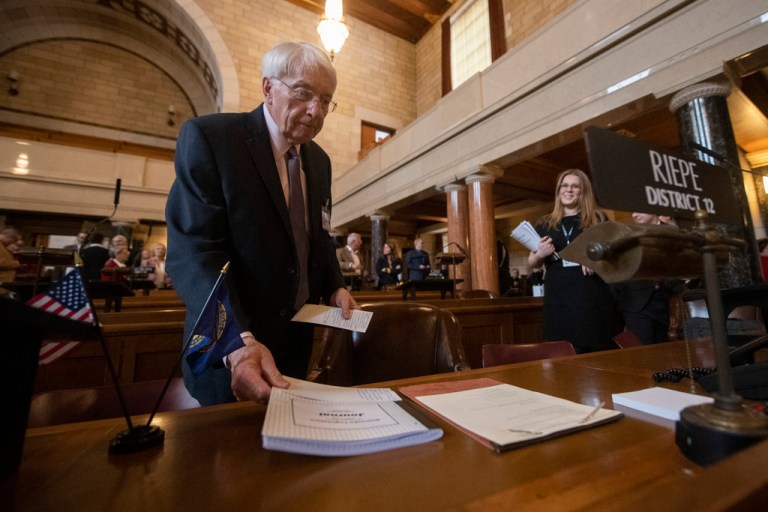 Sen. Merv Riepe sets down his notebook ahead of the first day of legislature on Jan. 4, 2023, at the Nebraska State Capitol in Lincoln, Nebraska. Nebraska lawmakers planned to begin debate Wednesday on a bill that would ban abortion once cardiac activity can be detected in an embryo, which is generally around the sixth week of pregnancy and before most women even know they are pregnant.  