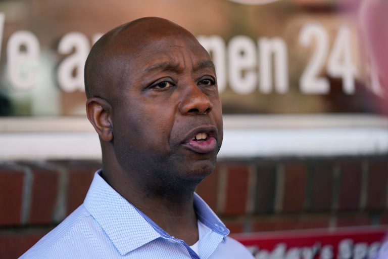 Sen. Tim Scott, R-S.C., talks with reporters during a visit to the Red Arrow Diner, Thursday, April 13, 2023, in Manchester, N.H. Scott on Wednesday launched an exploratory committee for a 2024 GOP presidential bid, a step that comes just shy of making his campaign official. 