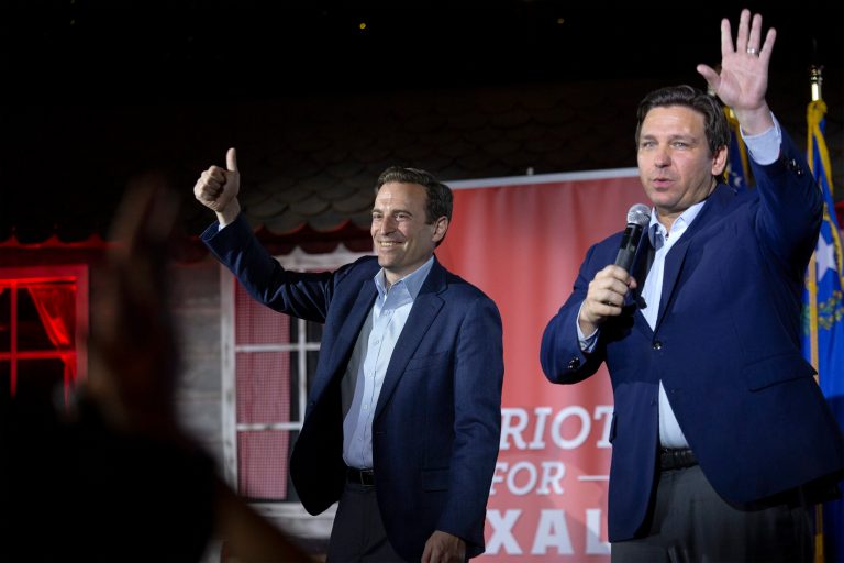 Nevada Republican U.S. Senate candidate Adam Laxalt and Florida Gov. Ron DeSantis, right, wave goodbye to the crowd during a rally for Laxalt on April 27, 2022, in Las Vegas. Former Nevada Attorney General Adam Laxalt will help lead a political action committee that is encouraging DeSantis to run for president.