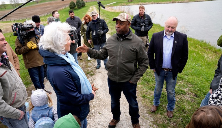 Sen. Tim Scott, R-S.C., center, talks with Linda Juckette, center left, as he tours her farm Saturday, April 22, 2023, in Cumming, Iowa. 