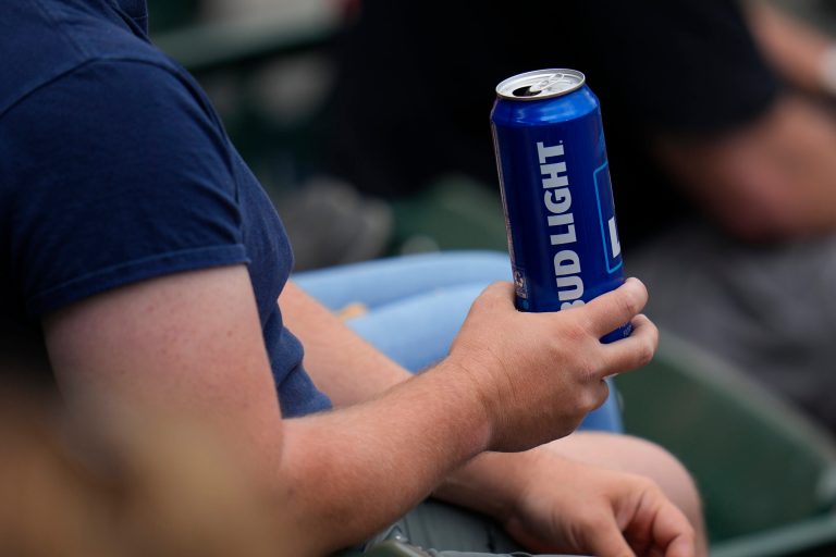 A spectator holds a can of Bud Light during the fifth inning of a baseball game between the Baltimore Orioles and the Boston Red Sox, Wednesday, April 26, 2023, in Baltimore. (AP Photo/Julio Cortez)