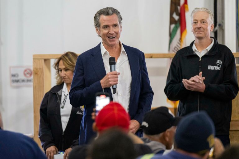 California Gov. Gavin Newsom talks with workers during a stop at World Energy Paramount in Paramount, Calif., Monday, May 1, 2023.