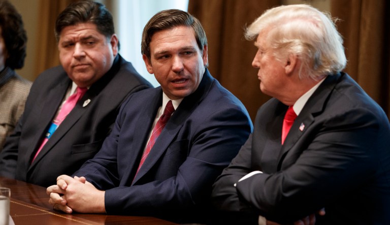 Gov.-elect Ron DeSantis, R-Fla., talks with President Donald Trump during a meeting with newly elected governors in the Cabinet Room of the White House, Dec. 13, 2018, in Washington. From left, Governor-elect J.B. Pritzker, D-Ill., DeSantis, and Trump.