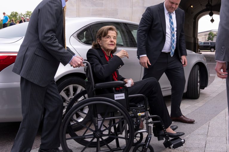 FILE - Sen. Dianne Feinstein, D-Calif., is assisted to a wheelchair by staff as she returns to the Senate after a more than two-month absence, at the Capitol in Washington, Wednesday, May 10, 2023. 