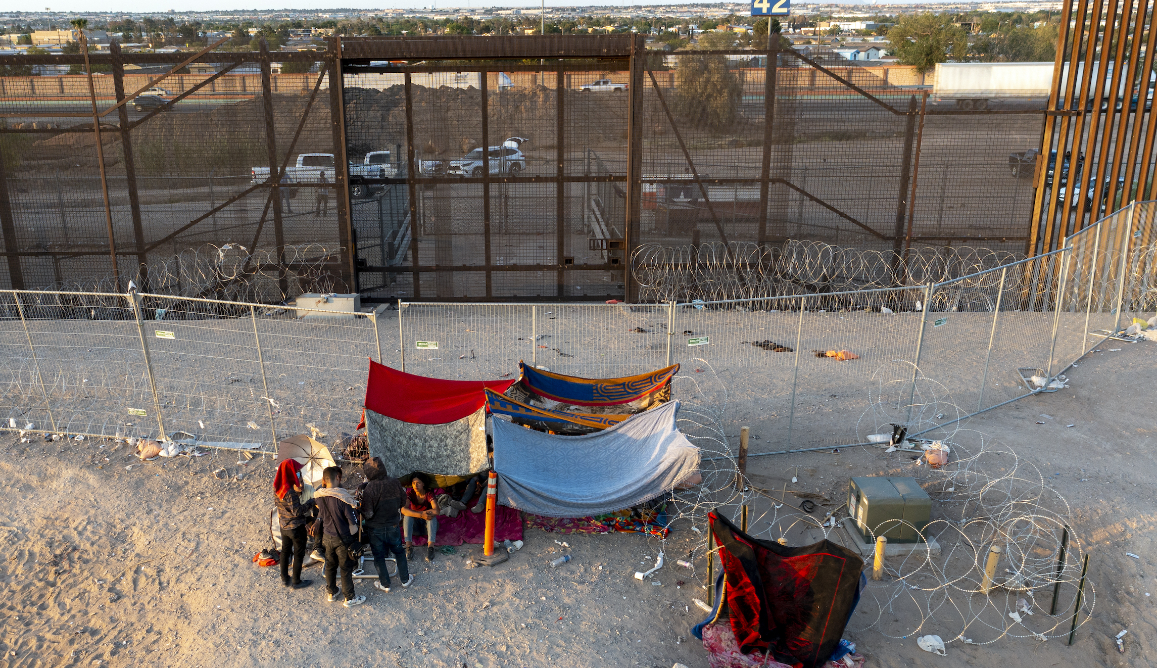Immigrants parade across El Paso border in chaotic scene