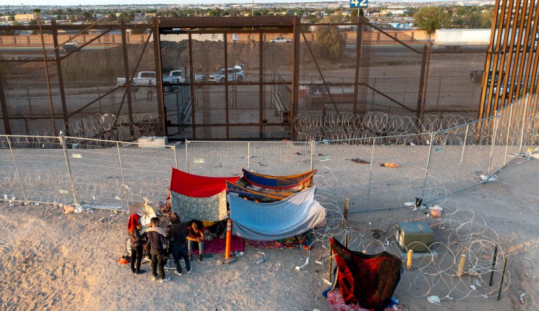 Immigrants parade across El Paso border in chaotic scene