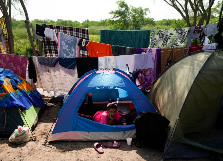 A Venezuelan migrant rests inside her tent on the bank of the Rio Grande in Matamoros, Mexico, Sunday, May 14, 2023. As the U.S. ended its pandemic-era immigration restrictions, migrants are adapting to new asylum rules and legal pathways meant to discourage illegal crossings.