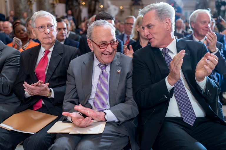 From left, Senate Minority Leader Mitch McConnell, R-Ky., Senate Majority Leader Chuck Schumer, D-N.Y., and Speaker of the House Kevin McCarthy, R-Calif., take time out from their struggle over the debt limit negotiations as they applaud during a portrait-unveiling ceremony for former Speaker of the House Paul Ryan, R-Wis., at the Capitol in Washington, Wednesday, May 17, 2023. 