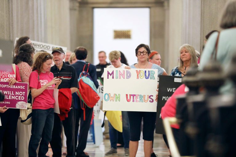 Protesters against a stricter ban on abortion in South Carolina stand in the Statehouse lobby on Tuesday, May, 23, 2023, in Columbia, South Carolina. 