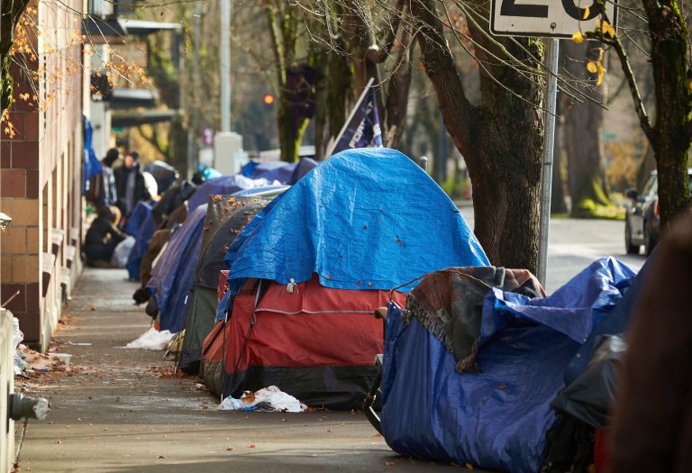 FILE - Tents line the sidewalk on SW Clay St in Portland, Ore., on Dec. 9, 2020. 