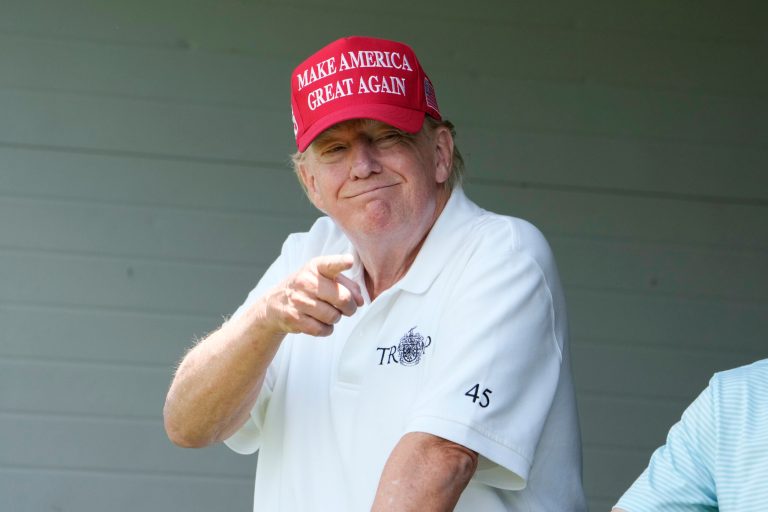 Former President Donald Trump smiles at fans in the crowd, during the first round of the LIV Golf Tournament at Trump National Golf Club, Friday, May 26, 2023, in Sterling, Virginia. (AP Photo/Alex Brandon)