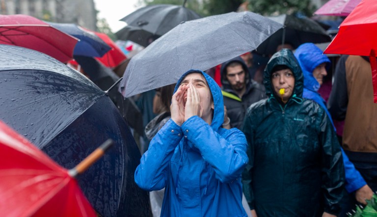 A young woman shouts as she attends a protest in front of the state-run TV headquarters in Belgrade, Serbia, Saturday, May 27, 2023. The protests in Belgrade and other Serbian cities are the biggest in years against Serbian president Aleksandar Vucic and his government. They were organized in response to a pair of mass shootings earlier this month that left 18 people dead and 20 wounded, many of them children from an elementary school.