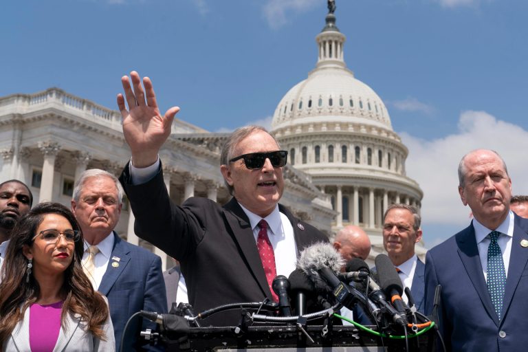 Rep. Andy Biggs, (R-AZ), center, speaks with other lawmakers in the conservative House Freedom Caucus at a news conference to voice their objections to the debt limit deal reached by Speaker of the House Kevin McCarthy, R-(CA), and President Joe Biden, at the Capitol in Washington, Tuesday, May 30, 2023. (AP Photo/J. Scott Applewhite)