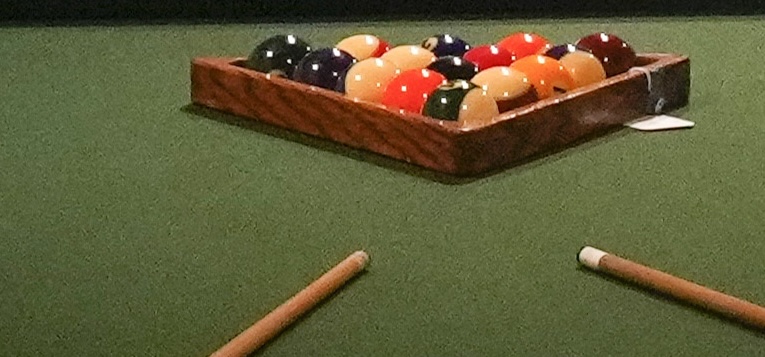 A pool table is displayed along with other film and entertainment memorabilia as part of the 