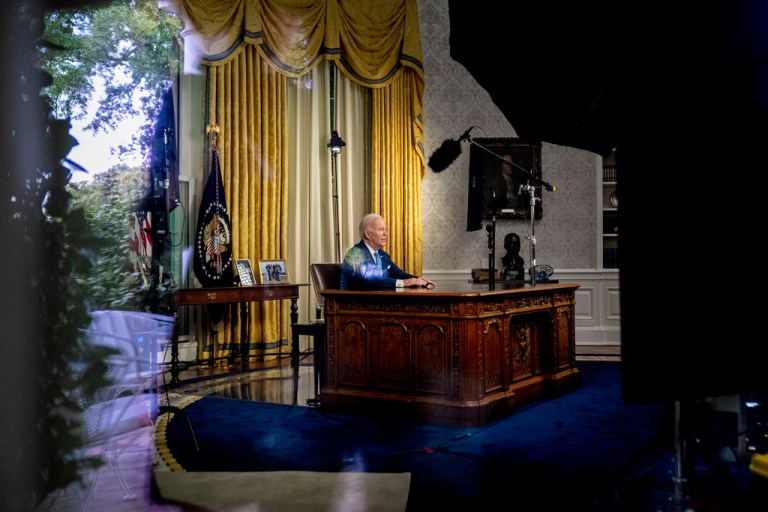 As seen through a window, President Joe Biden addresses the nation on the budget deal that lifts the federal debt limit and averts a U.S. government default, from the Oval Office.