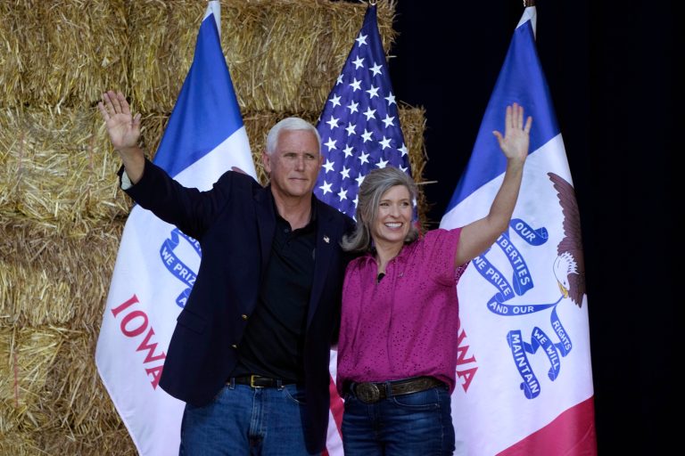 Former Vice President Mike Pence stands onstage with Sen. Joni Ernst (R-IA) during her Roast and Ride, Saturday, June 3, 2023, in Des Moines, Iowa.
