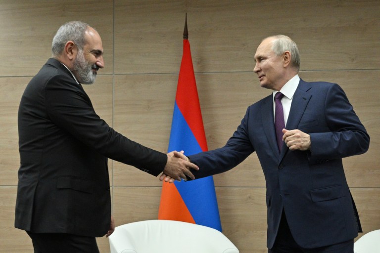 Russian President Vladimir Putin, right, and Armenian Prime Minister Nikol Pashinyan shakes hands during their meeting in the resort city of Sochi, Russia, Friday, June 9, 2023.