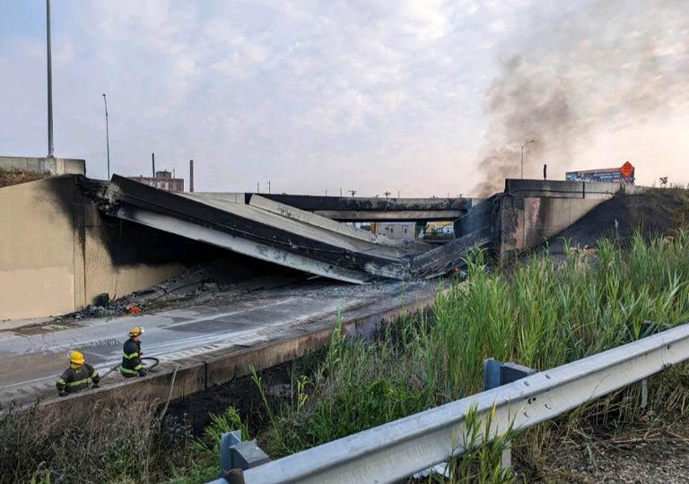 This image provided by the Office of Emergency Management shows firefighters standing near the collapsed part of I-95 in Philadelphia on Sunday, June 11, 2023. The elevated section of Interstate 95 has collapsed early Sunday after a vehicle caught fire, closing the main north-south highway on the East Coast and threatening to upend travel in parts of the densely populated Northeast.