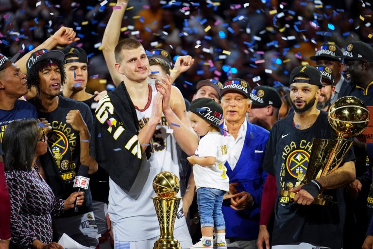 Denver Nuggets center Nikola Jokic, center left, celebrates with teammates after the team won the NBA Championship with a victory over the Miami Heat in Game 5 of basketball's NBA Finals, Monday, June 12, 2023, in Denver. 