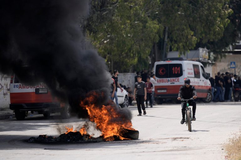 Tires burn surging clashes between Israeli forces and Palestinian militants in the West Bank city of Jenin on Monday, June 19, 2023.