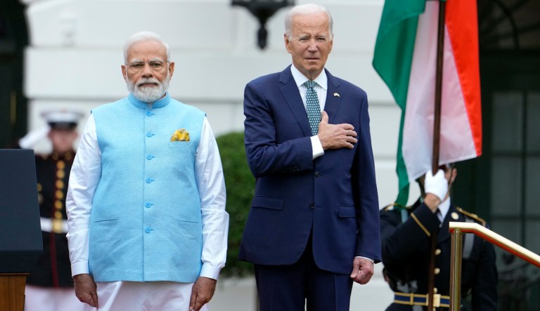 Biden slowly lowers his hand from his heart during the Indian national anthem