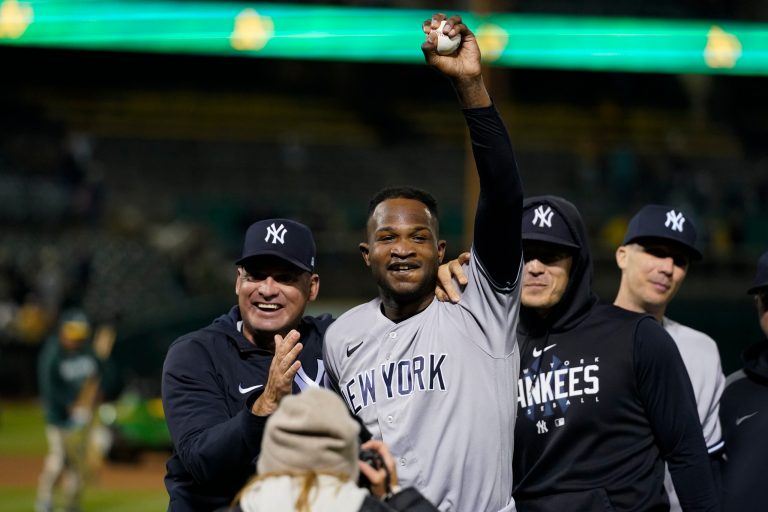 New York Yankees' Domingo German, center, celebrates after pitching a perfect game against the Oakland Athletics during a baseball game in Oakland, California, on Wednesday, June 28, 2023. The Yankees won 11-0.