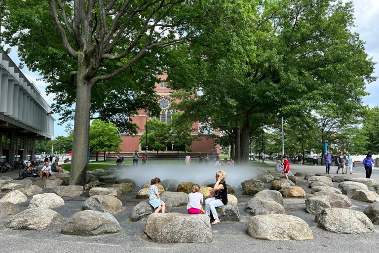 People relax near a fountain at Harvard University, Thursday, June 29, 2023, in Cambridge, Massachusetts.
