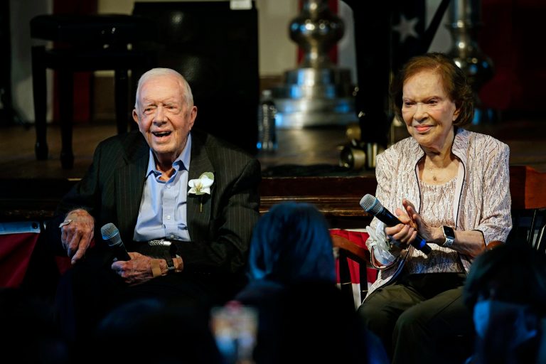Former President Jimmy Carter and his wife Rosalynn Carter sit together during a reception to celebrate their 75th wedding anniversary.