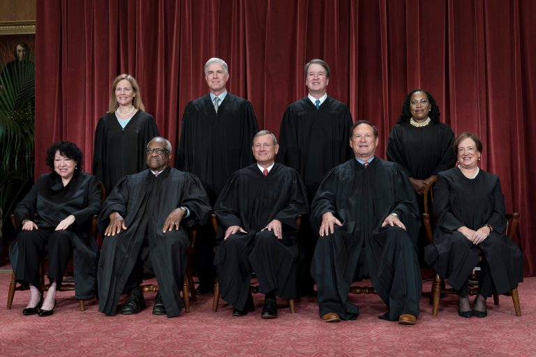 FILE - Members of the Supreme Court sit for a new group portrait following the addition of Associate Justice Ketanji Brown Jackson, at the Supreme Court building in Washington, Oct. 7, 2022.