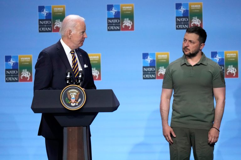 United States President Joe Biden, left, addresses a media conference with other G7 countries and Ukraine's President Volodymyr Zelenskyy, right, during a NATO summit in Vilnius, Lithuania, Wednesday, July 12, 2023.