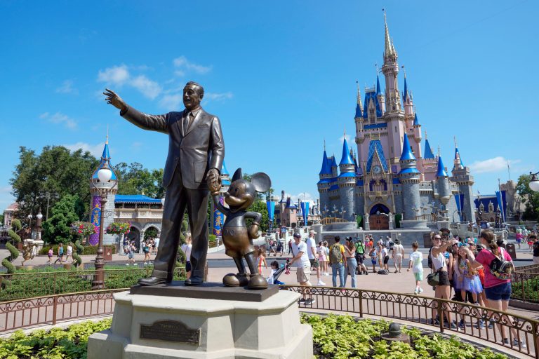 Park guests stroll past the statue of Walt Disney and Mickey Mouse in the Magic Kingdom at Walt Disney World Friday, July 14, 2023, in Lake Buena Vista, Florida.