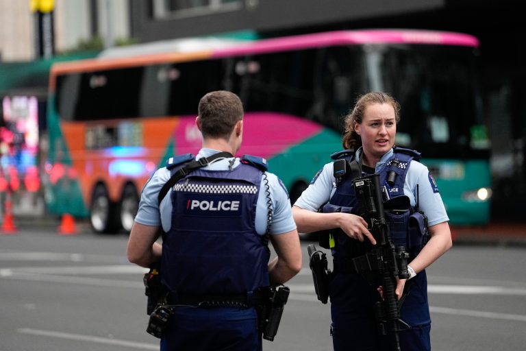 Armed New Zealand police officers stand outside a hotel housing a team from the FIFA Women's World Cup in the central business district following a shooting in Auckland, New Zealand, Thursday, July 20, 2023. 