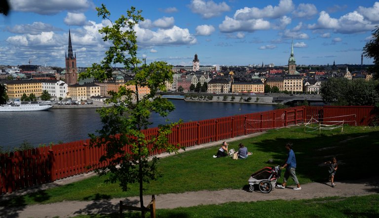 People enjoy sunny weather in a park in Stockholm, Sweden, Thursday, July 27, 2023.