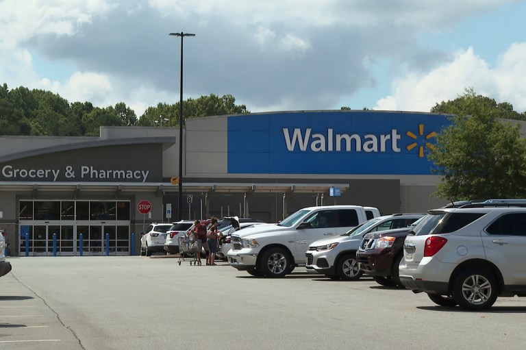 In this image taken from video, shoppers load purchased items into their vehicle Monday, July 31, 2023, at a Walmart in Lincolnton, North Carolina. (AP Photo/Erik Verduzco)