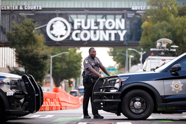 A sheriff's deputy looks on near the Fulton County Courthouse, Monday, Aug. 14, 2023, in Atlanta. Court officials in Atlanta published a list of criminal charges against former President Donald Trump.