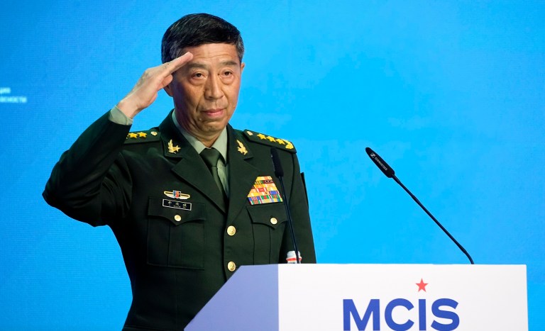 Chinese Defense Minister Li Shangfu salutes as he arrives to deliver his speech at the International Military Forum Army-2023 in the Patriot Park in Moscow, Russia, Tuesday, Aug. 15, 2023. The Moscow Conference on International Security is held at the Army Forum, Russia's main military showcase event that began just outside Moscow on Monday.
