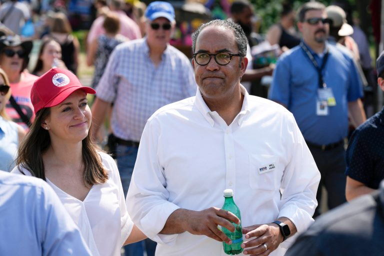 Republican presidential candidate Will Hurd walks with his wife, Lynlie, during a visit to the Iowa State Fair, Friday, Aug. 18, 2023, in Des Moines, Iowa.