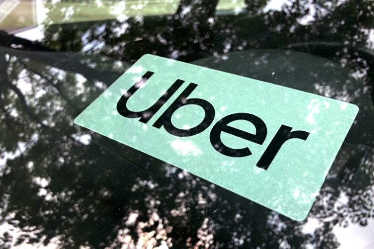 FILE- An Uber sign is displayed inside a car in Palatine, Ill., Monday, May 22, 2023. (AP Photo/Nam Y. Huh,File)