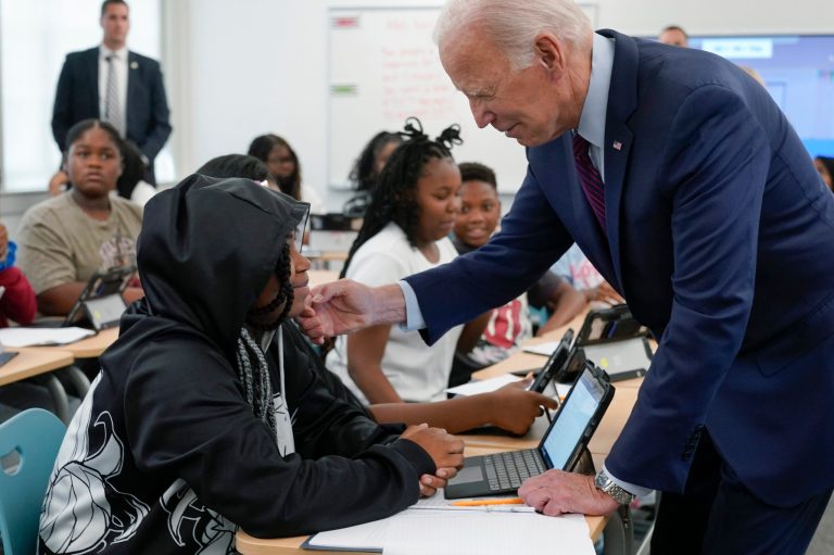 President Joe Biden talks with a student at Eliot-Hine Middle School on Monday, Aug. 28, 2023, in Washington as he and first lady Jill Biden visit the school, located east of the U.S. Capitol, to mark the District of Columbia's first day of school for the 2023-24 year. 