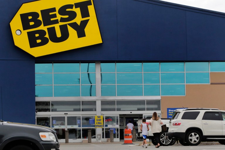 FILE - A woman walks with a boy to the Best Buy store at the Mall of New Hampshire, Tuesday, Aug. 4, 2020, in Manchester, N.H.  Best Buy sales and profits slid in the second quarter, Tuesday, Aug. 29, 2023. (AP Photo/Charles Krupa, File)