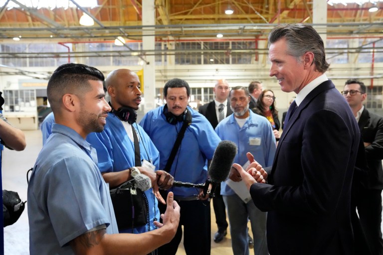 FILE - Incarcerated men visit with California Gov. Gavin Newsom after he spoke inside an empty warehouse at San Quentin State Prison in San Quentin, Calif., Friday, March 17, 2023.  (AP Photo/Eric Risberg, File)