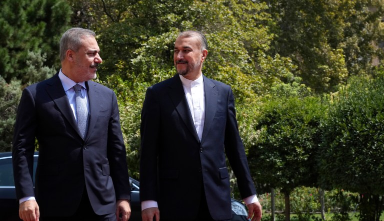 Turkish Foreign Minister Hakan Fidan, left, is welcomed by his Iranian counterpart Hossein Amirabdollahian, in Tehran, Iran, Sunday, Sept. 3, 2023.