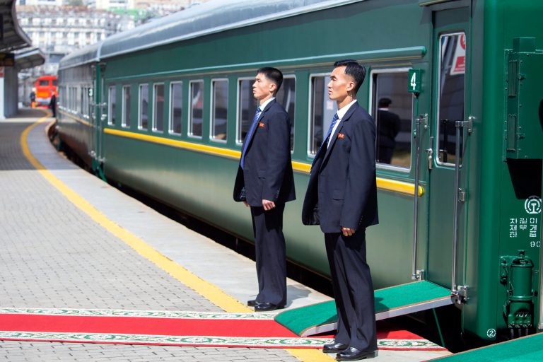North Korea's security officers wait for North Korean leader Kim Jong Un near the train as he leaves Russia.